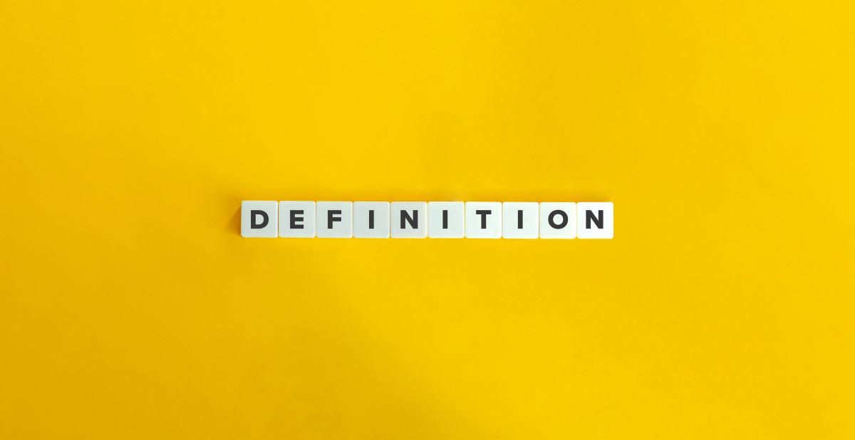 Definition spelt out in scrabble letters with a bright yellow background.